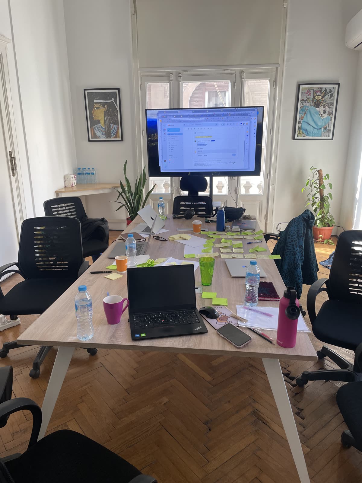 A workshop table with planning notes and laptops