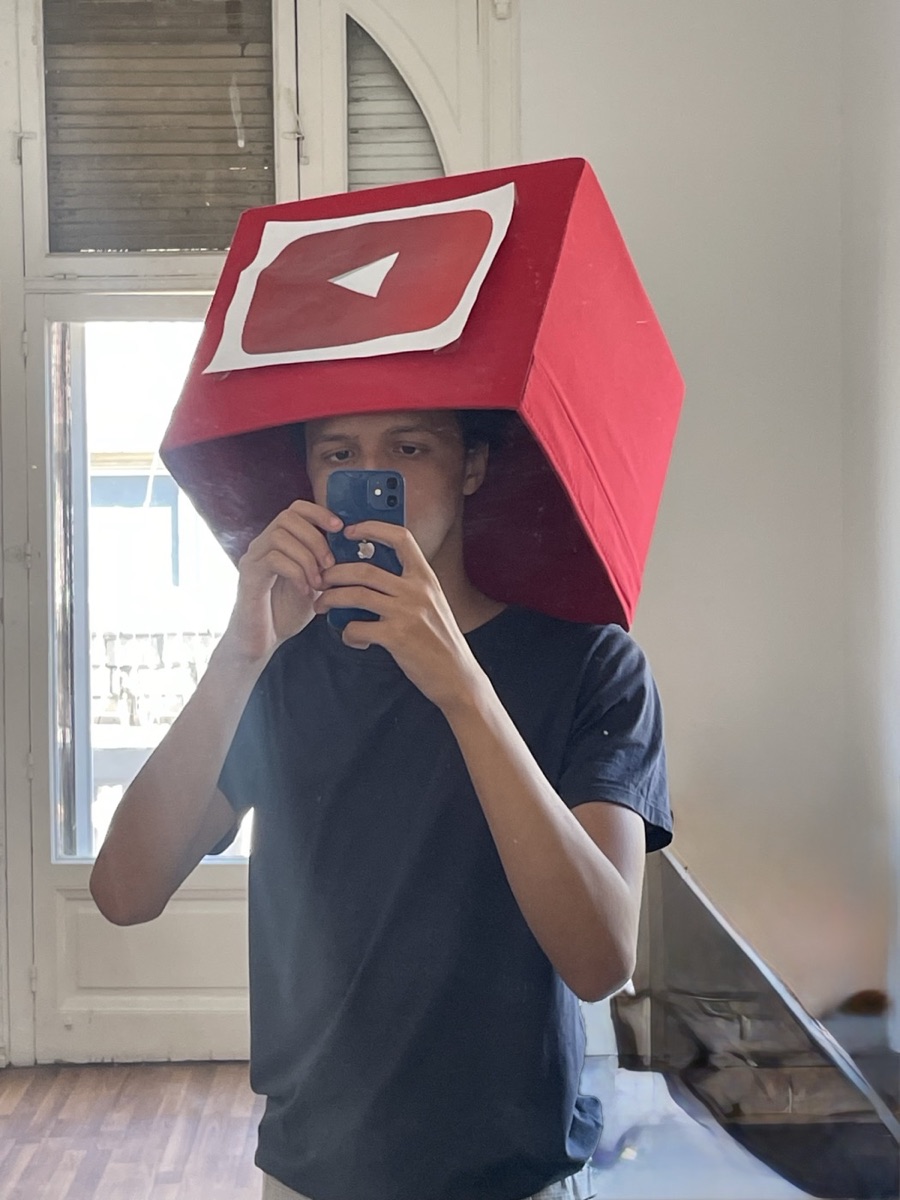 Mahmoud wearing a handmade YouTube play-button box